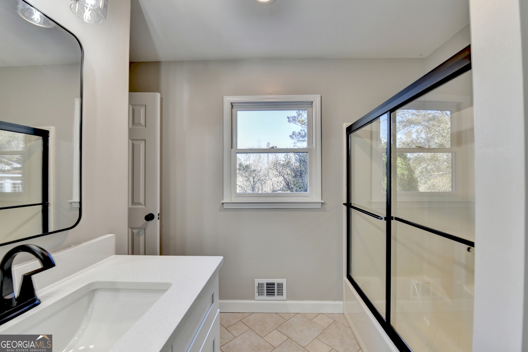 590 Manning Gin Road Monroe, GA 30656 - Photo 35 of 82 a bathroom with a sink and a large mirror