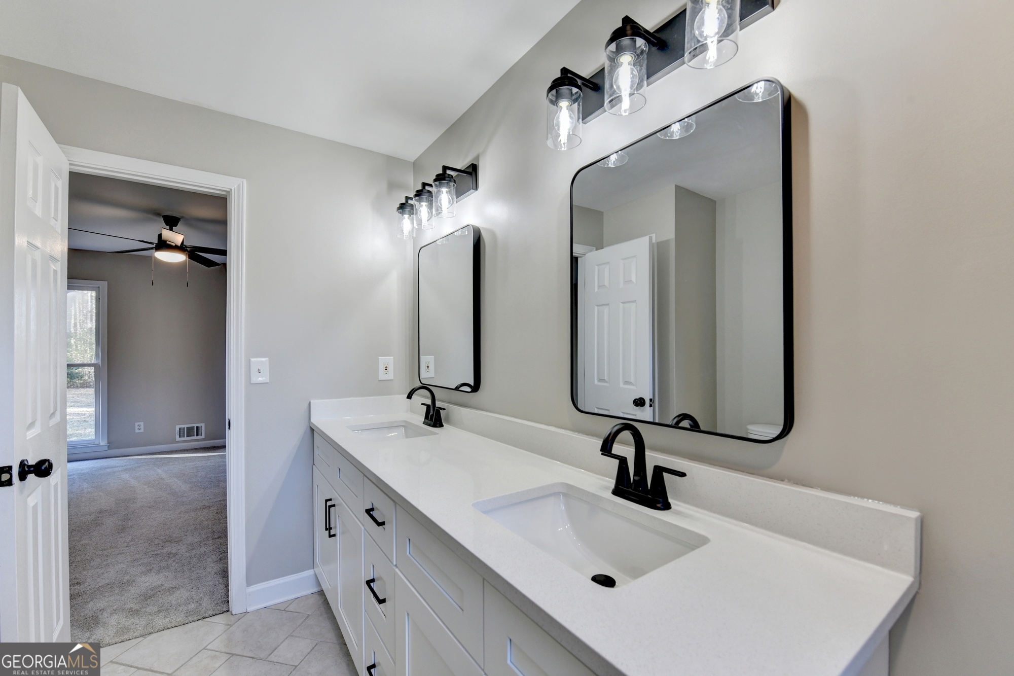 590 Manning Gin Road Monroe, GA 30656 - Photo 36 of 82 a bathroom with a sink double vanity and a mirror