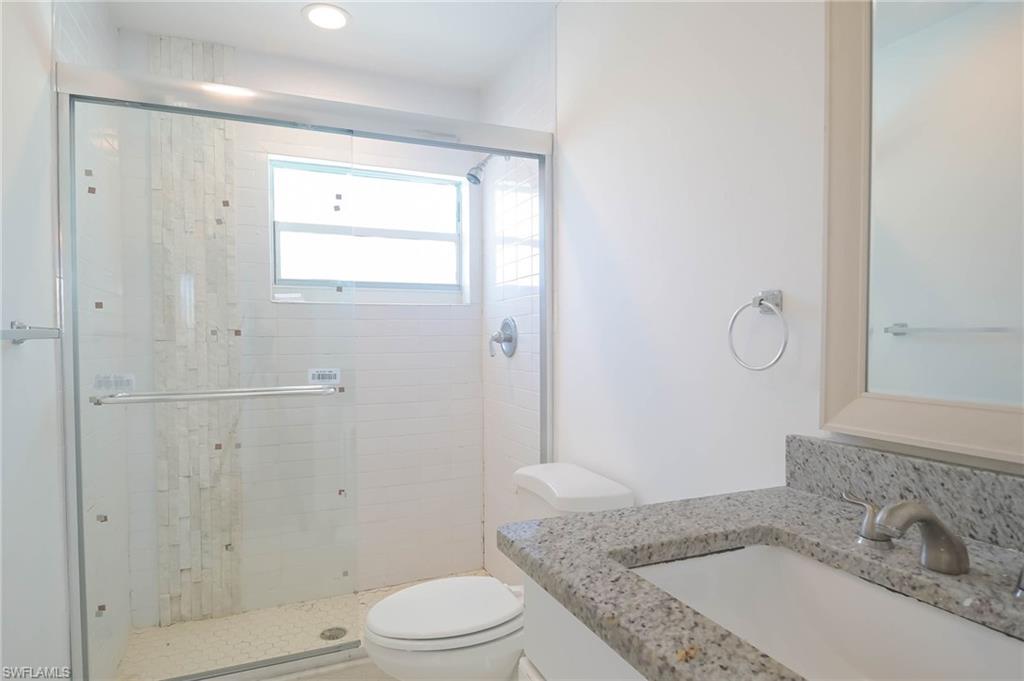 9104 Pineapple Road Fort Myers, FL 33967 - Photo 12 of 24 a bathroom with a granite countertop sink toilet and shower