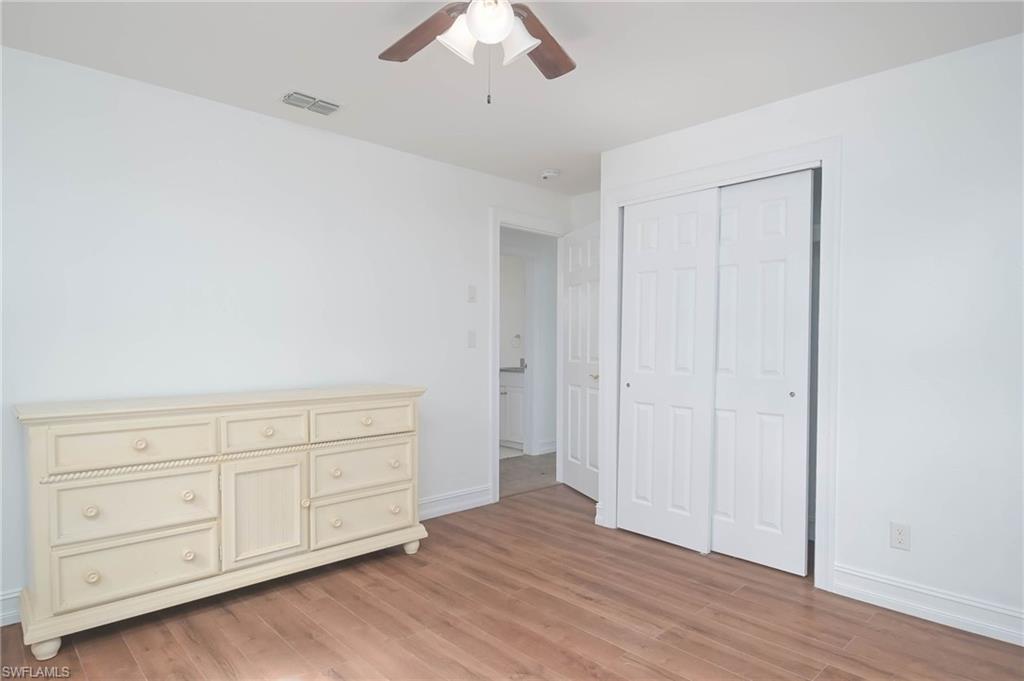 9104 Pineapple Road Fort Myers, FL 33967 - Photo 16 of 24 an empty room with wooden floor closet and windows