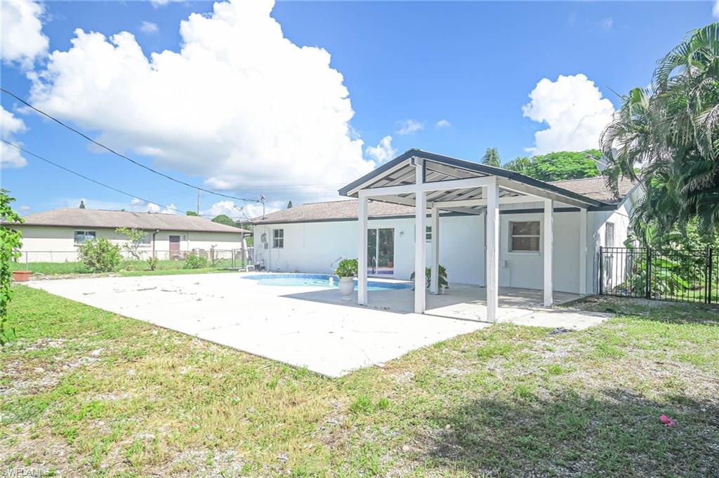 9104 Pineapple Road Fort Myers, FL 33967 - Photo 20 of 24 a front view of a house with a porch and a yard