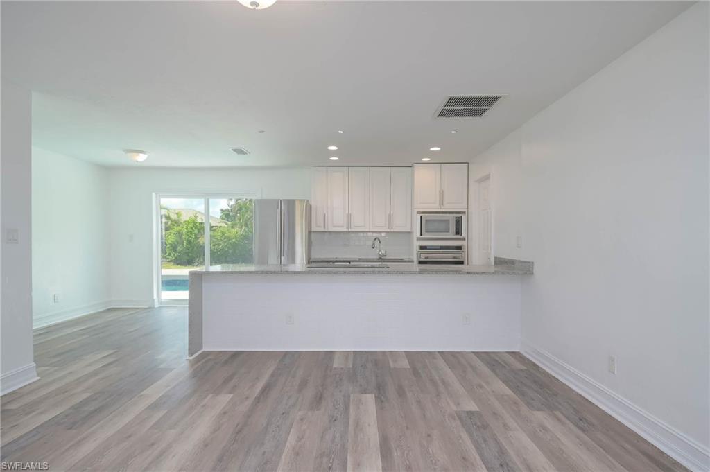 9104 Pineapple Road Fort Myers, FL 33967 - Photo 3 of 24 a view of kitchen with wooden floor and electronic appliances