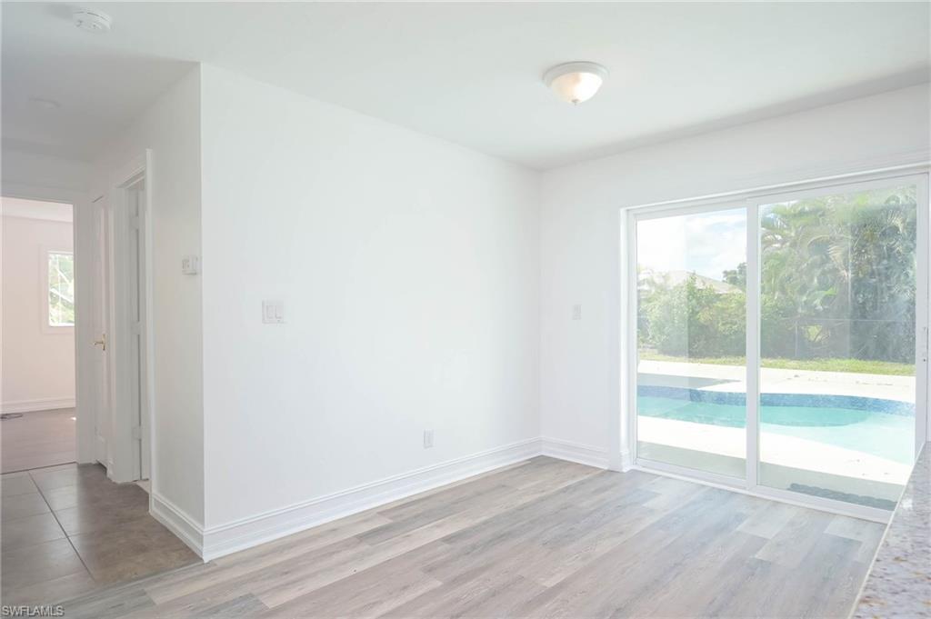 9104 Pineapple Road Fort Myers, FL 33967 - Photo 6 of 24 an empty room with wooden floor and windows