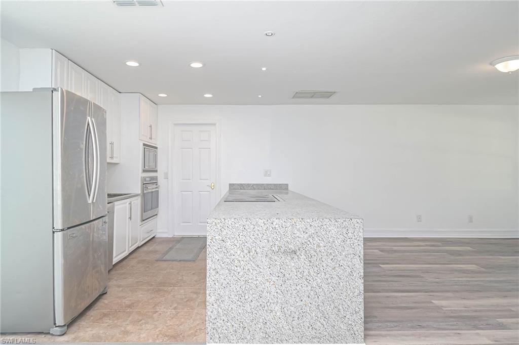 9104 Pineapple Road Fort Myers, FL 33967 - Photo 7 of 24 a kitchen with a refrigerator and microwave