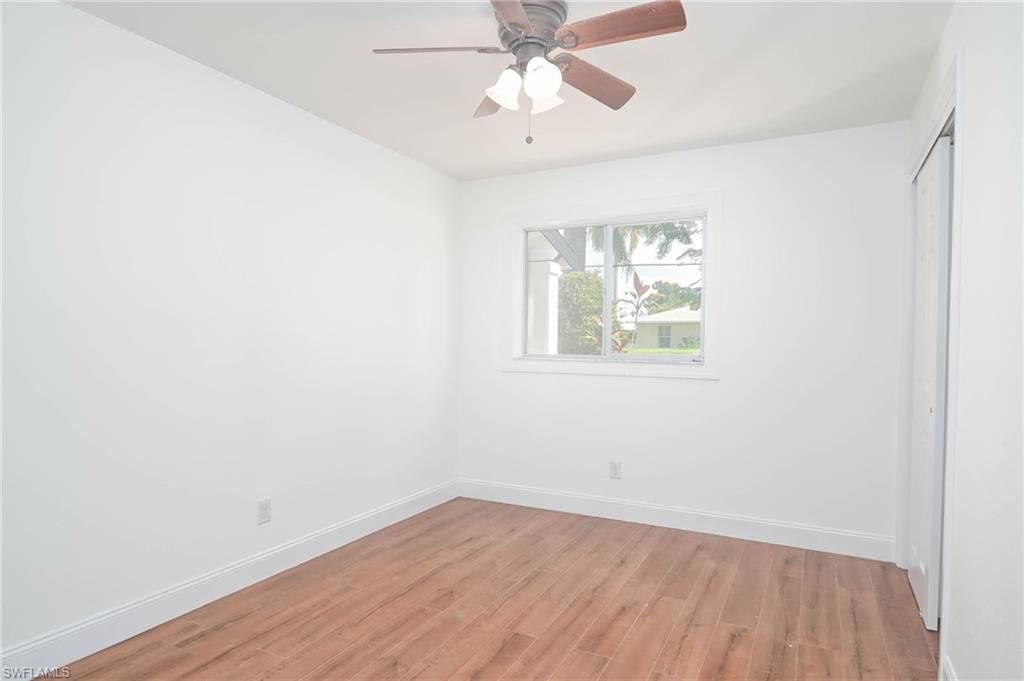 9104 Pineapple Road Fort Myers, FL 33967 - Photo 10 of 24 an empty room with a window and wooden floor