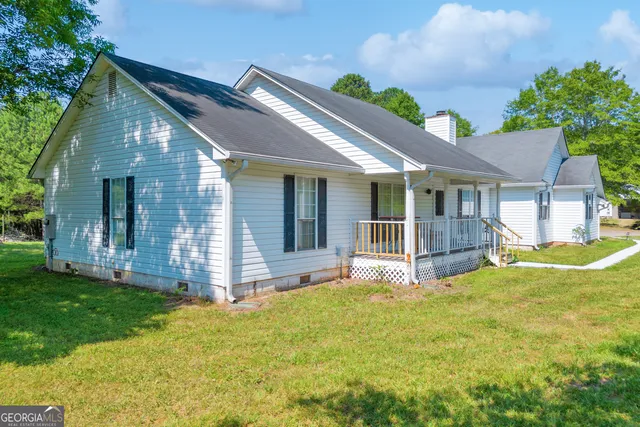 a view of a house with a yard and porch