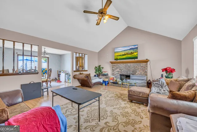 a living room with furniture a window and a fireplace