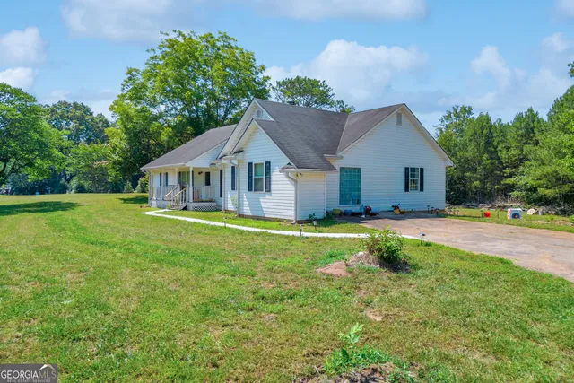 a front view of a house with swimming pool and porch