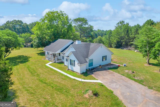 an aerial view of a house with garden space and street view
