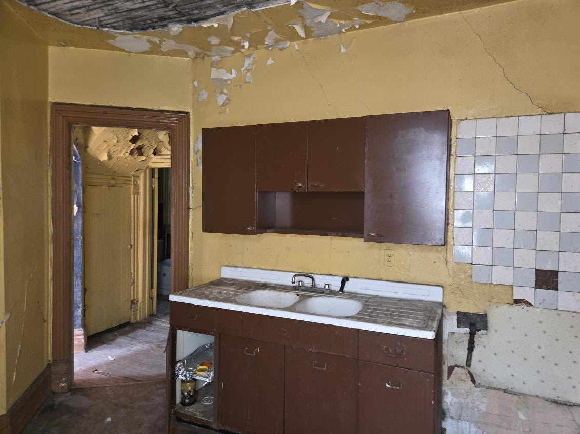 636 West 62nd Street Chicago, IL 60621 - Photo 12 of 16 a bathroom with a sink and a mirror