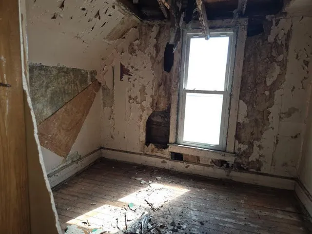 a view of a closet area with wooden floor