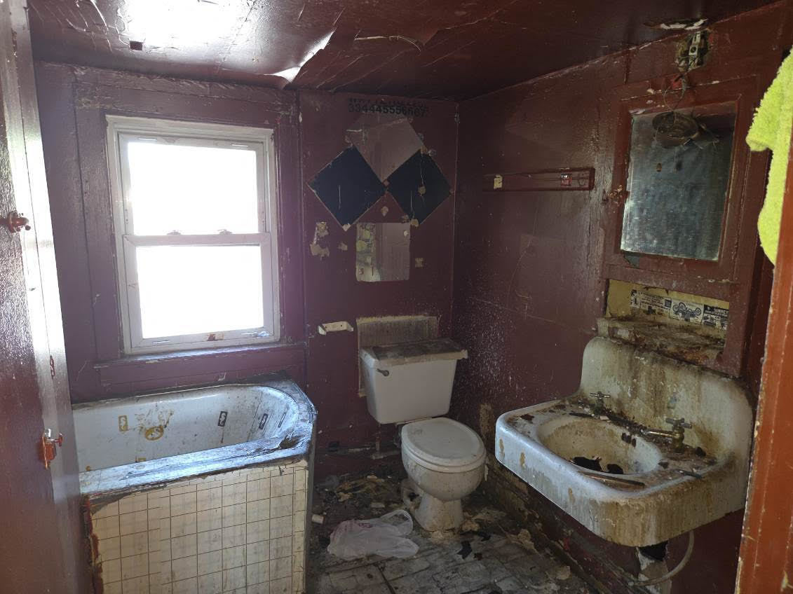 636 West 62nd Street Chicago, IL 60621 - Photo 15 of 16 a white toilet sitting next to a bathroom sink and tub