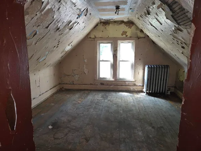 an empty room with a fireplace