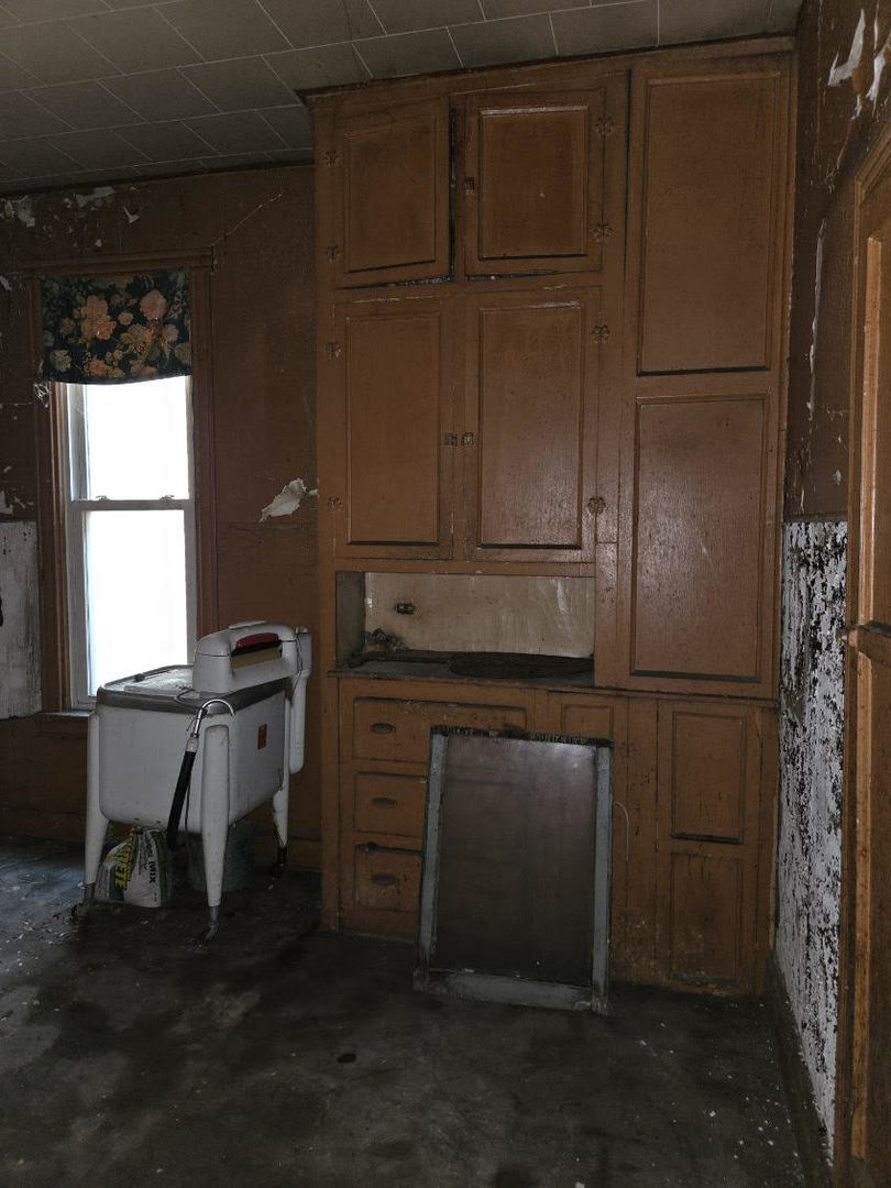 636 West 62nd Street Chicago, IL 60621 - Photo 6 of 16 a kitchen with a refrigerator and window
