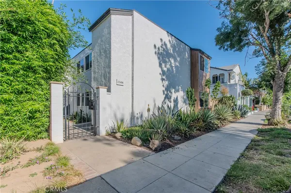 a kitchen with stainless steel appliances a stove a sink and a refrigerator