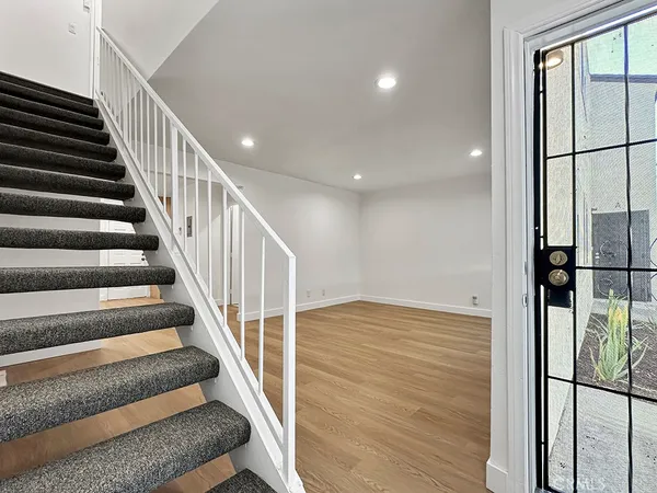a kitchen with granite countertop a stove and a wooden floor