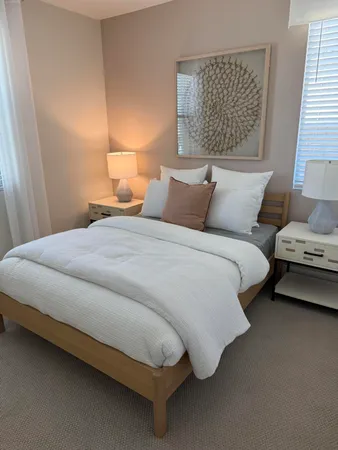 a bedroom with bed and window