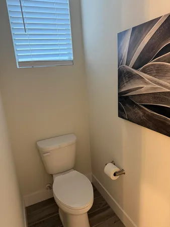 a toilet sitting in a bathroom next to a sink