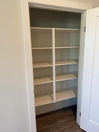 a view of walk in closet with empty racks