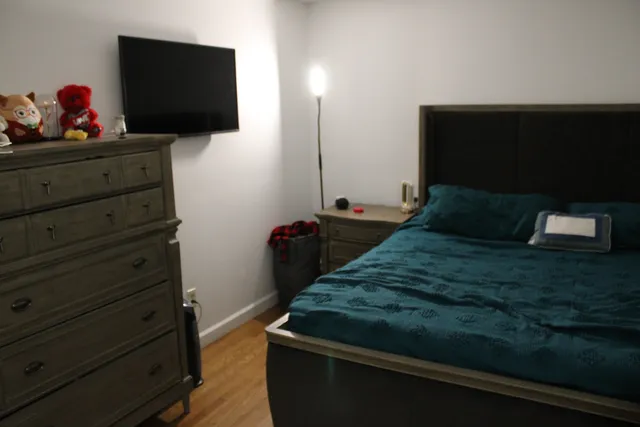 a bedroom with a bed and flat screen tv