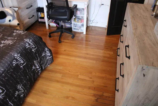 a balcony with chairs and wooden floor