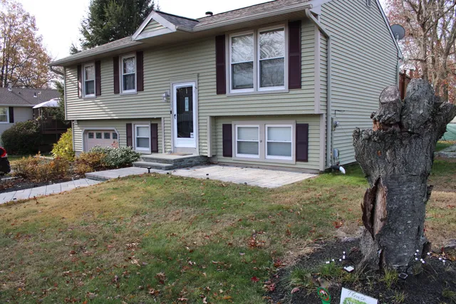 a view of a house with yard and tree s