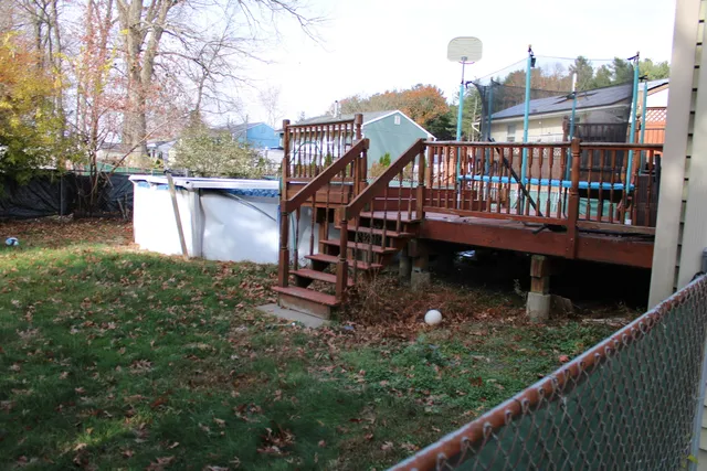 a balcony with tall trees in front of it