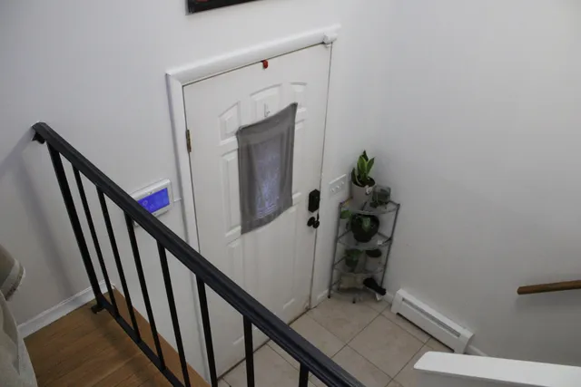 a view of entryway and hall with wooden floor