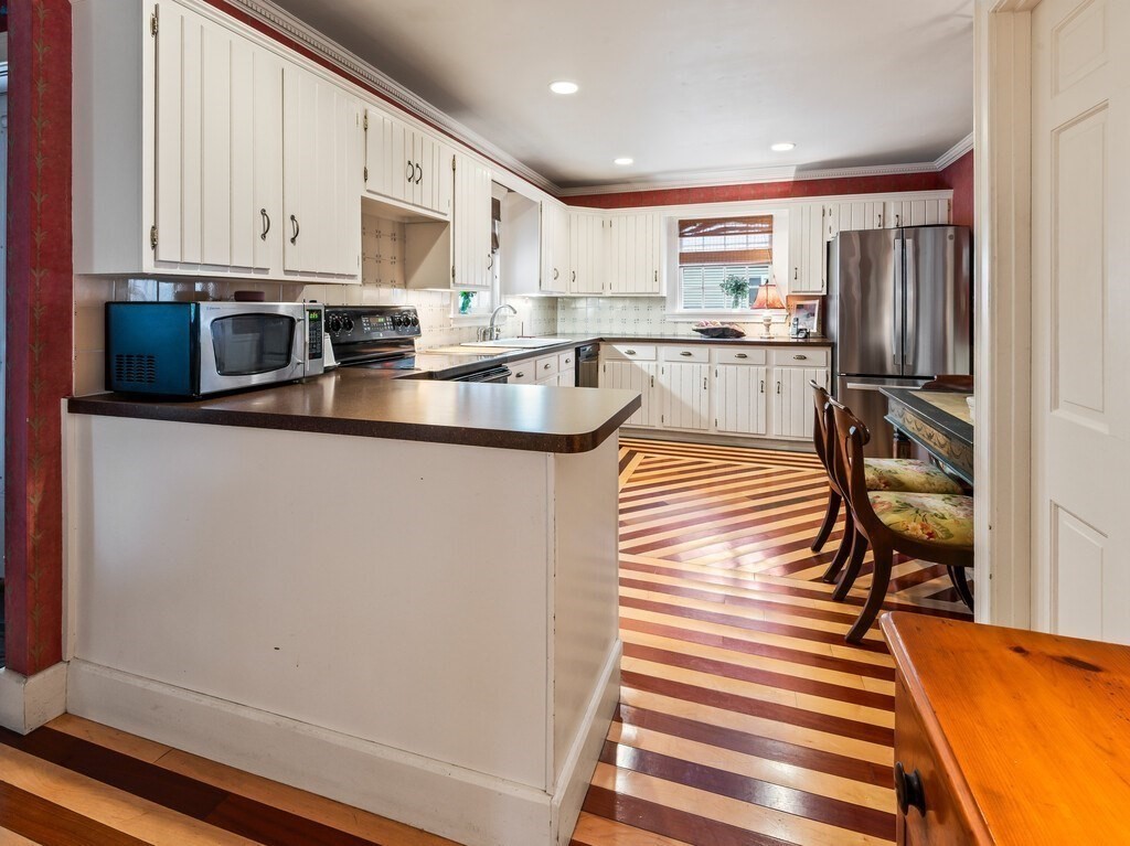 20 Manhattan Road Worcester, MA 01602 - Photo 12 of 41 a kitchen with stainless steel appliances granite countertop a refrigerator a stove and a cabinets