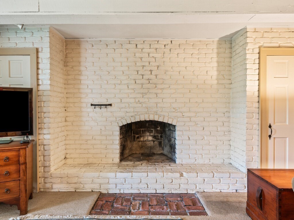 20 Manhattan Road Worcester, MA 01602 - Photo 29 of 41 a living room with a fireplace and a flat screen tv