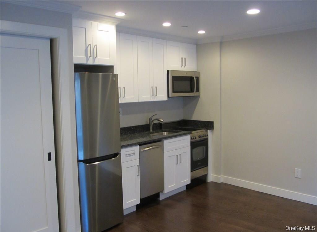 17 Cedar Street, Unit 3 Dobbs Ferry, NY 10522 - Photo 2 of 7 a kitchen with stainless steel appliances a refrigerator sink and microwave