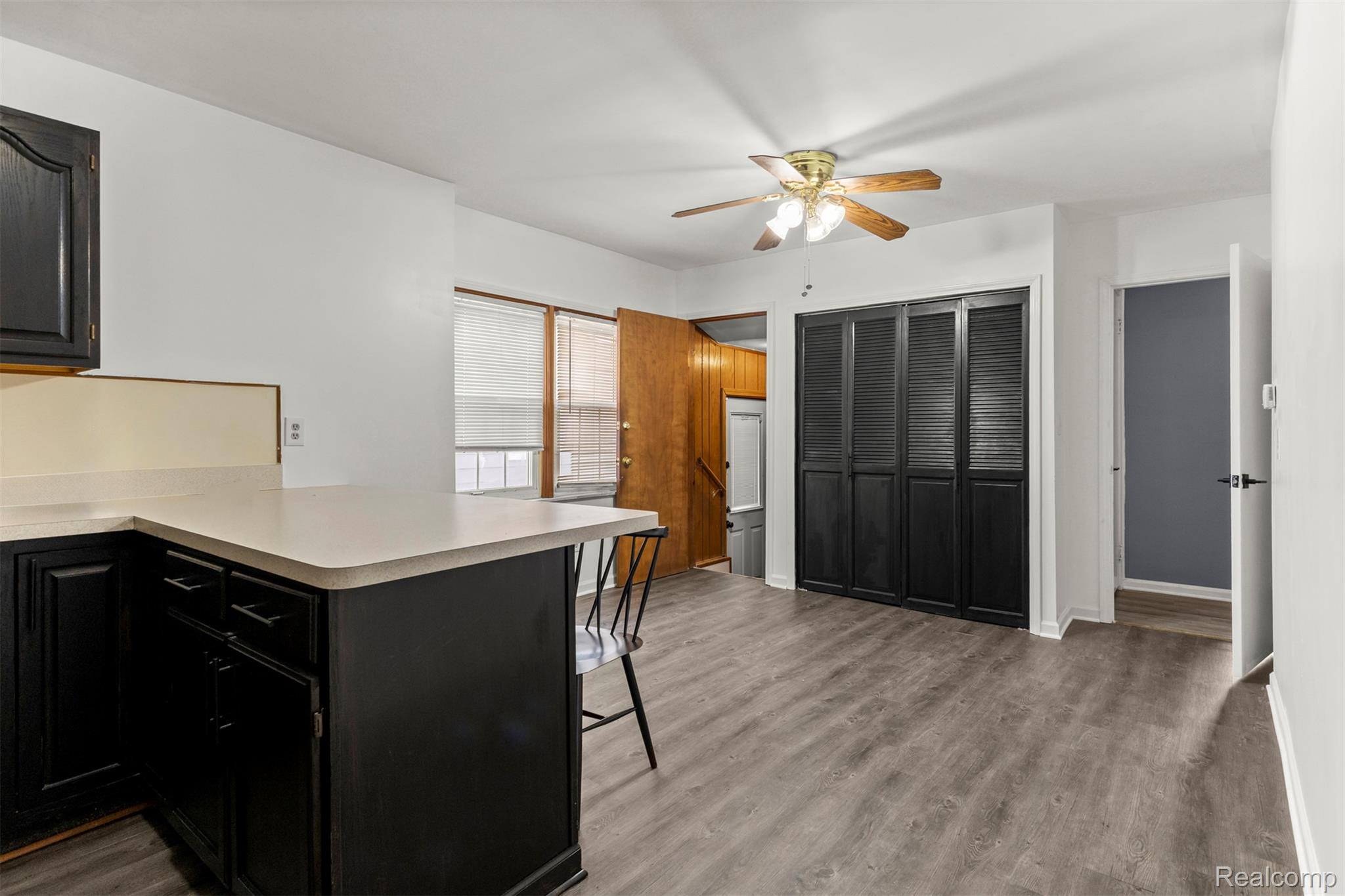 14716 Eureka Road Southgate, MI 48195 - Photo 12 of 42 Kitchen with dark cabinetry, a kitchen bar, a peninsula, light countertops, and a ceiling fan