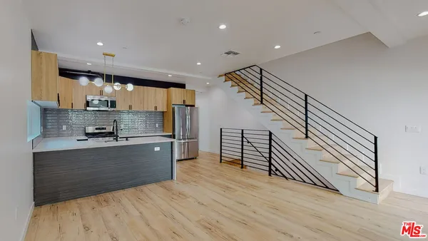 a view of kitchen with sink microwave and stove