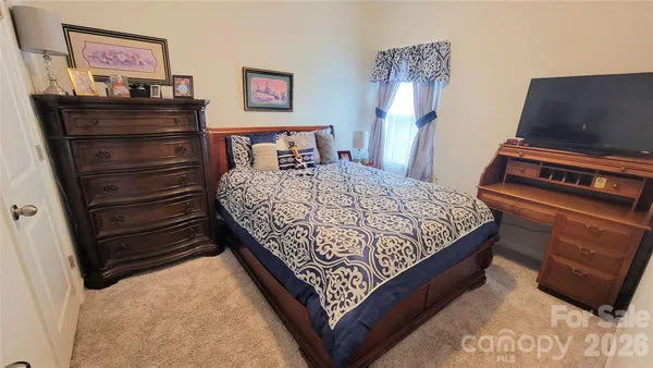a bed sitting in a bedroom and dresser