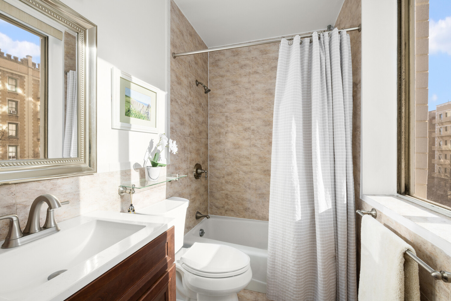 515 East 79th Street, Unit 4E Manhattan, NY 10075 - Photo 5 of 10 a bathroom with a sink a toilet and shower