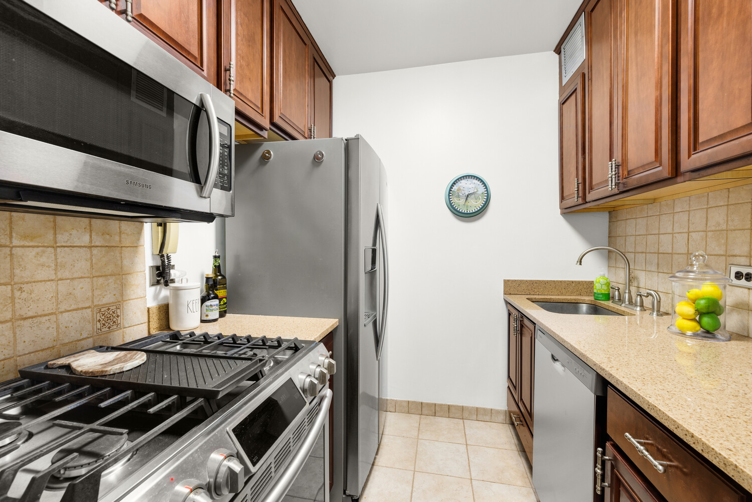 515 East 79th Street, Unit 4E Manhattan, NY 10075 - Photo 6 of 10 a kitchen with a stove and a refrigerator