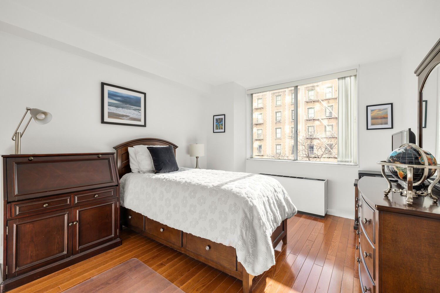 515 East 79th Street, Unit 4E Manhattan, NY 10075 - Photo 7 of 10 a bedroom with a bed and wooden floor