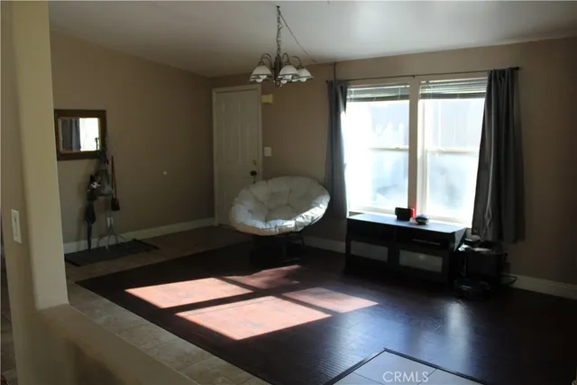 a room with a table chairs and a chandelier