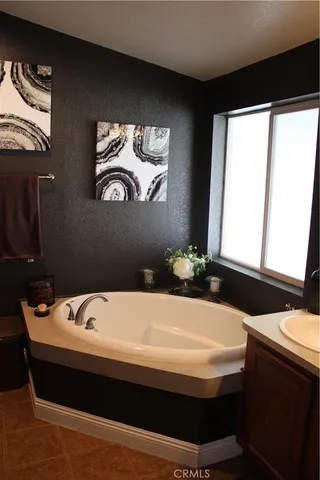 a bathroom with a sink a toilet a mirror and shower