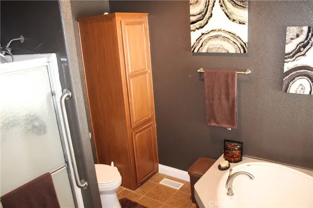 a bedroom with a bed and a lamp