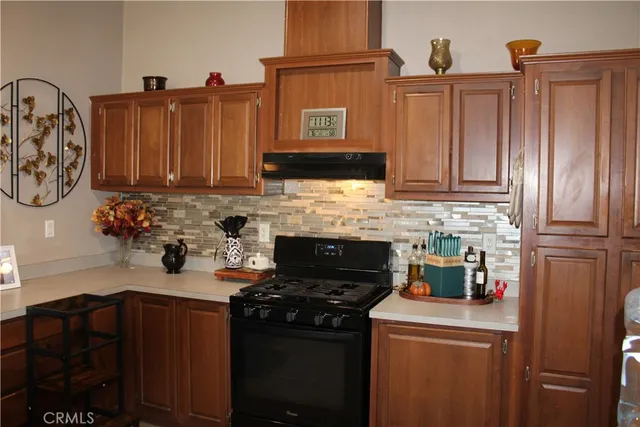 a living room with furniture two window and wooden floor
