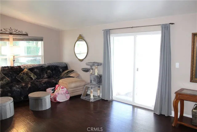 a kitchen with kitchen island granite countertop a sink and a refrigerator