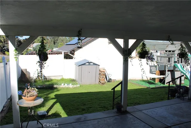 a view of a house with backyard and sitting area