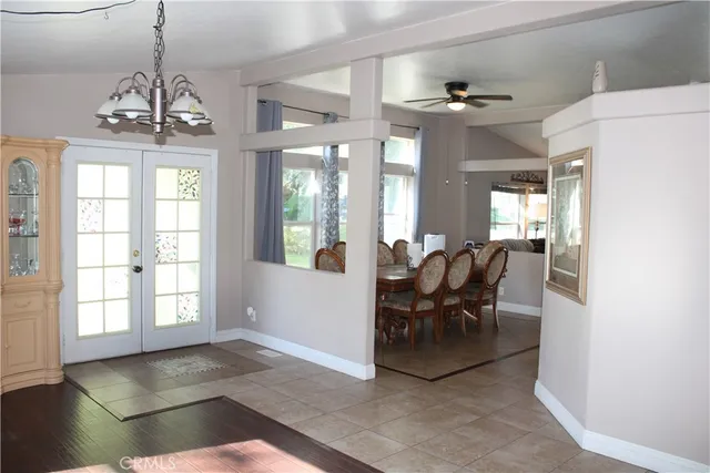 a view of a livingroom and a dining room with furniture window and wooden floor