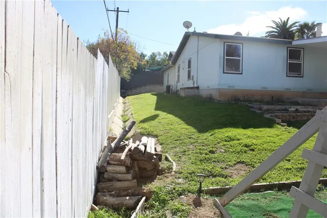 a backyard of a house with table and chairs