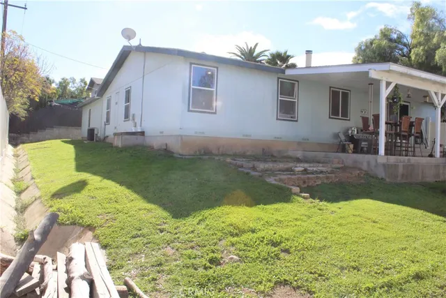 a front view of a house with a yard and potted plants