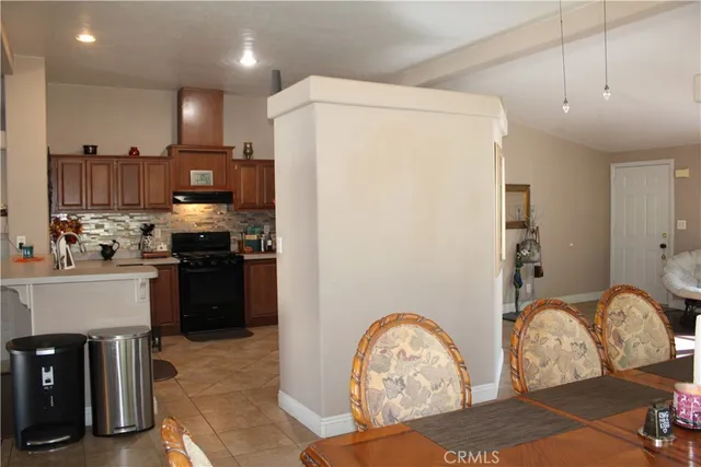 a kitchen with stainless steel appliances granite countertop a refrigerator sink and stove