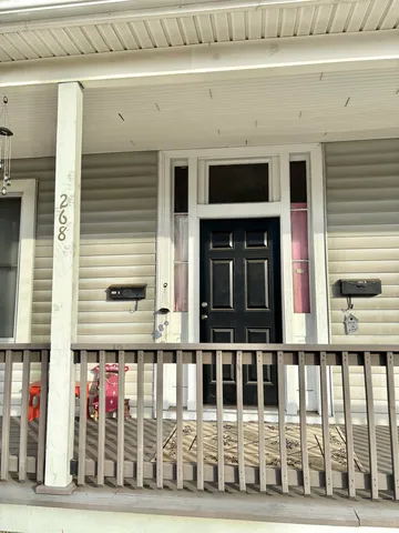 a view of a brick house with large windows