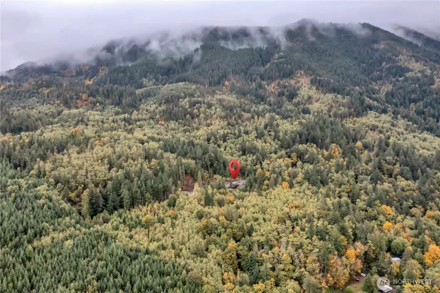 a view of a dry yard with mountains in the background