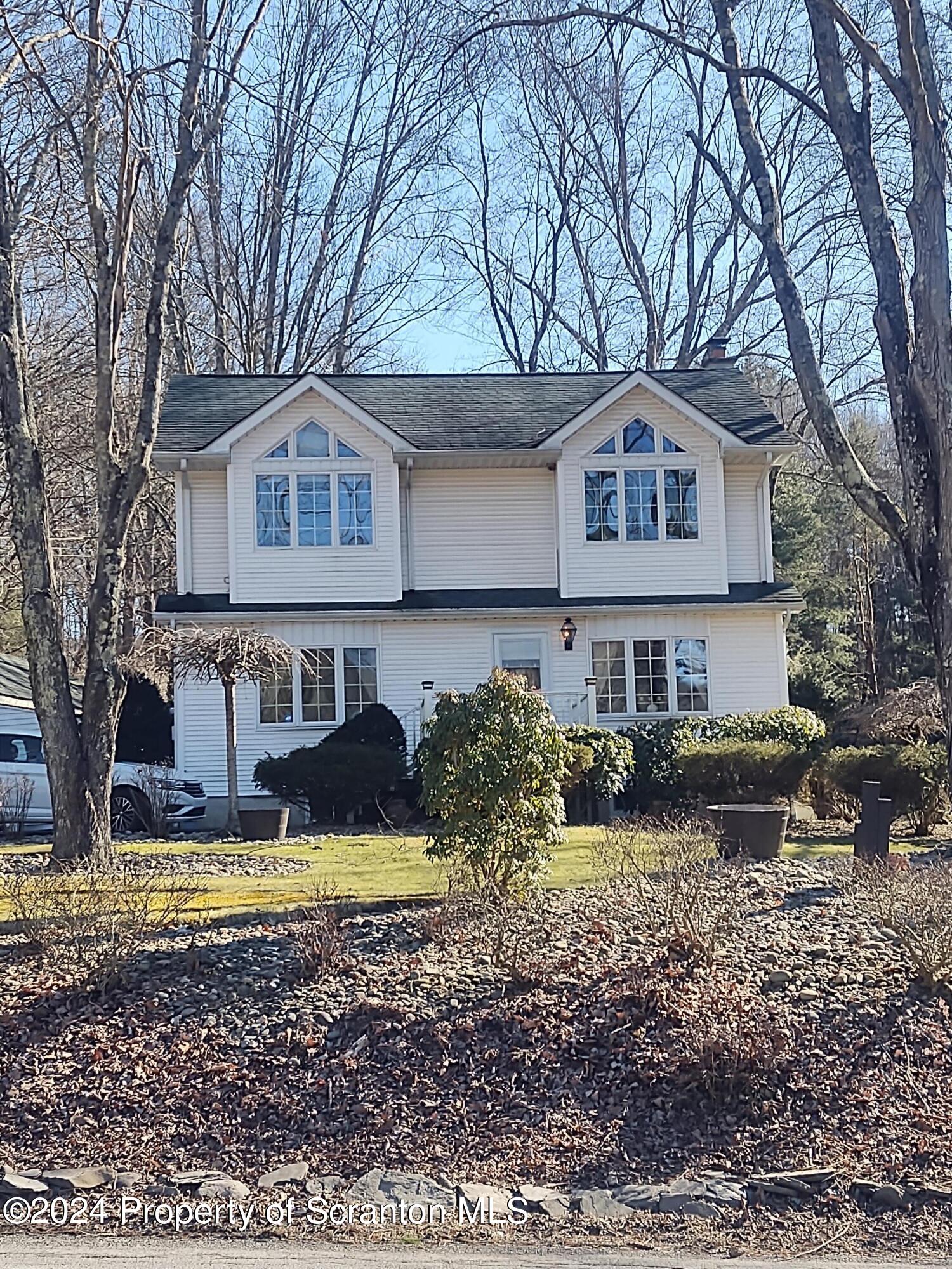 2401 Chase Road Shavertown, PA 18708 - Photo 3 of 19 a front view of a house with swimming pool next to a yard